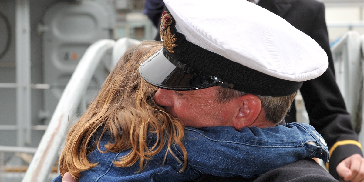 Officer hugging young child